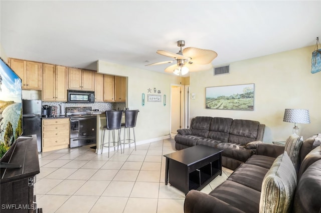 tiled living room with ceiling fan