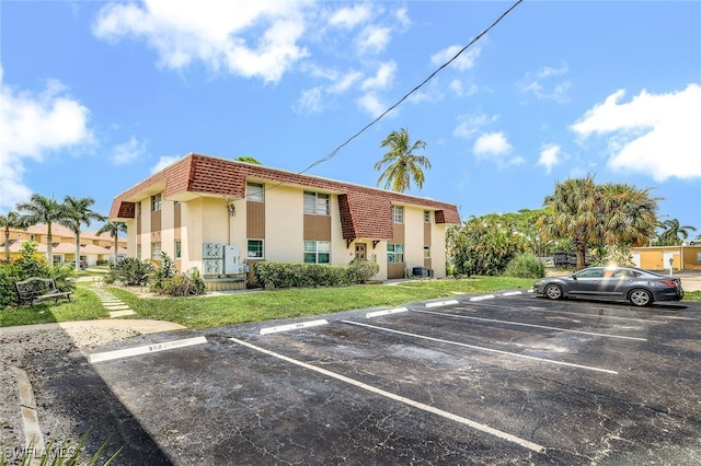 view of parking / parking lot with a yard