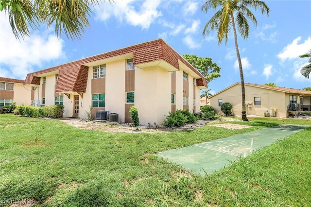 view of property exterior with a yard and cooling unit