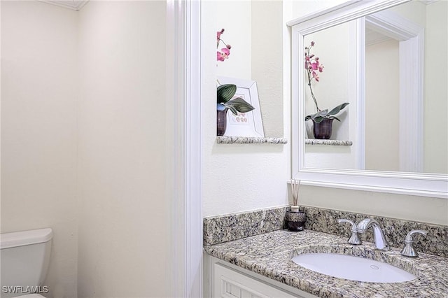 bathroom featuring vanity and toilet