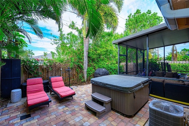 view of patio featuring a hot tub, grilling area, and central air condition unit