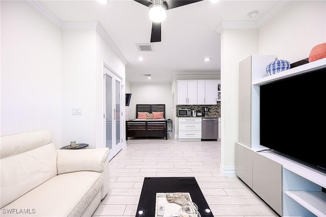 living room featuring ceiling fan and crown molding