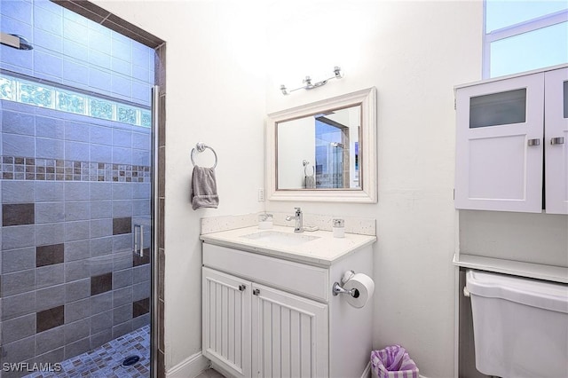 bathroom with vanity, toilet, an enclosed shower, and a wealth of natural light