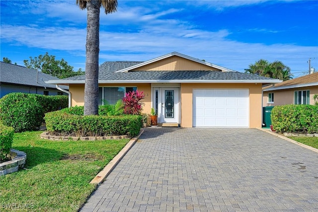 ranch-style house with a garage and a front lawn