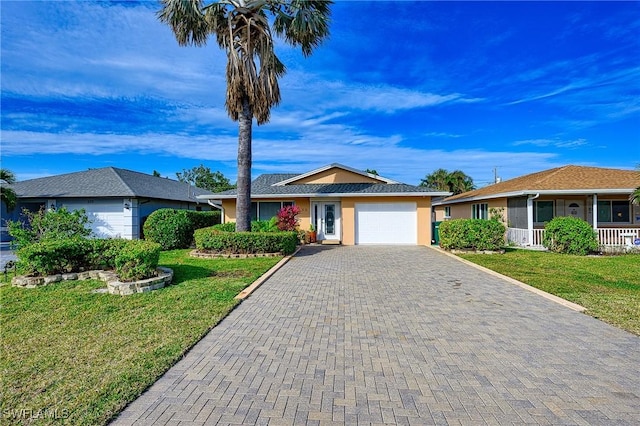 ranch-style house featuring a front yard and a garage