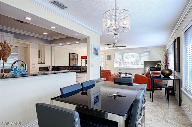 tiled dining room featuring a textured ceiling, ceiling fan with notable chandelier, and crown molding