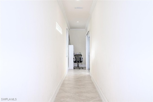 corridor featuring light tile patterned floors and crown molding