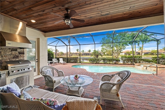 view of patio / terrace with a lanai, outdoor lounge area, a grill, and an outdoor kitchen