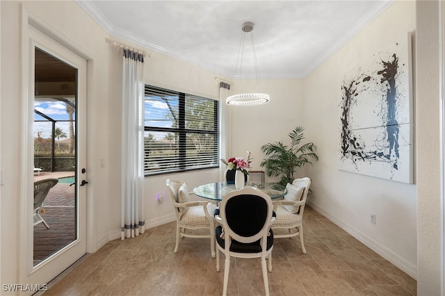 dining space featuring plenty of natural light, an inviting chandelier, and ornamental molding