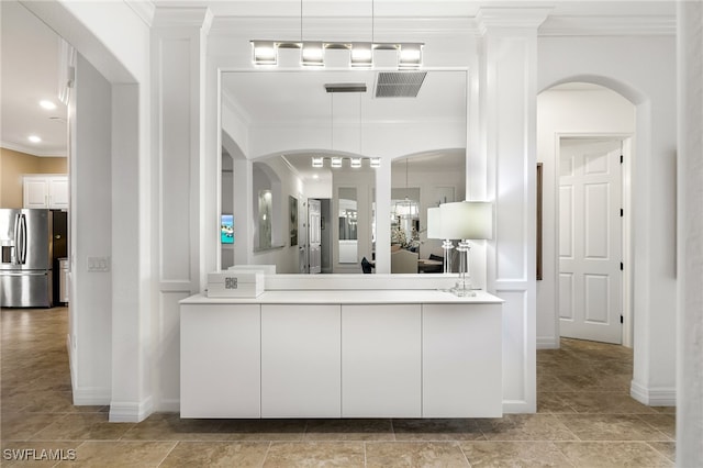 bathroom featuring crown molding and vanity