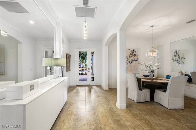 foyer featuring crown molding