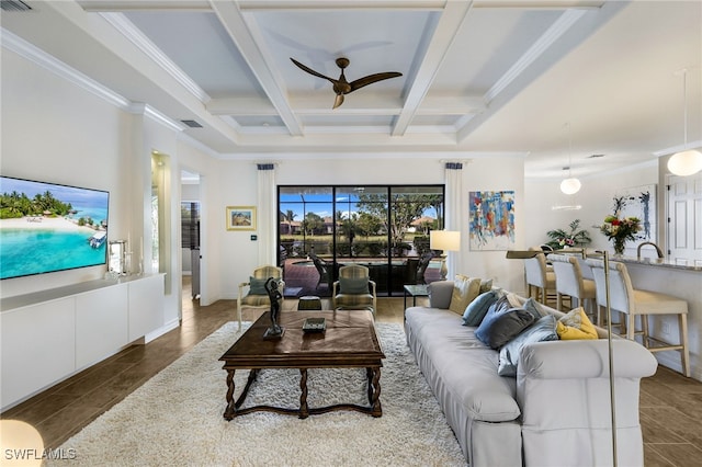 living room with beamed ceiling, ornamental molding, ceiling fan, and coffered ceiling