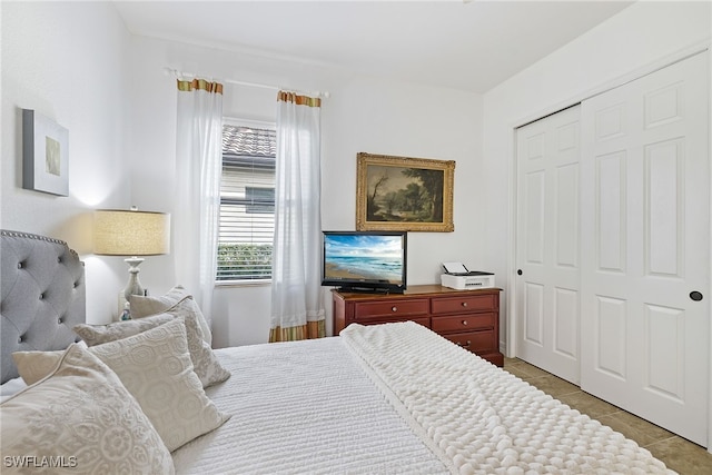 tiled bedroom featuring a closet