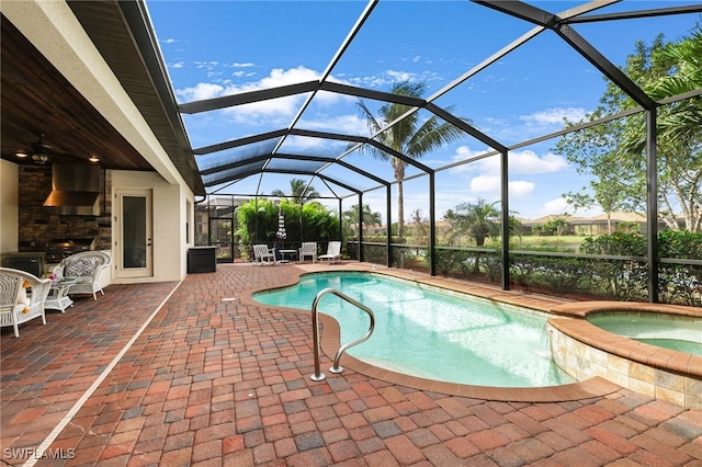 view of pool featuring an in ground hot tub, a patio, a lanai, and a grill