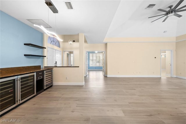 unfurnished living room with beverage cooler and ceiling fan