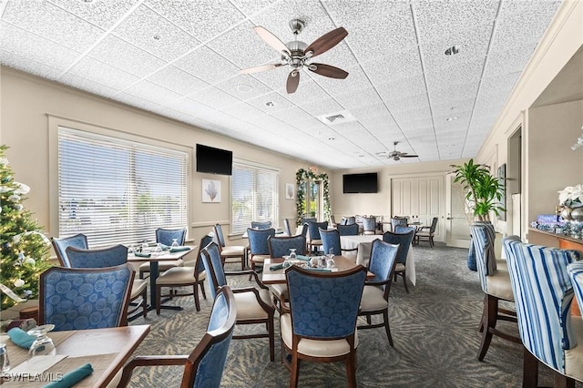 dining room featuring dark colored carpet and ceiling fan