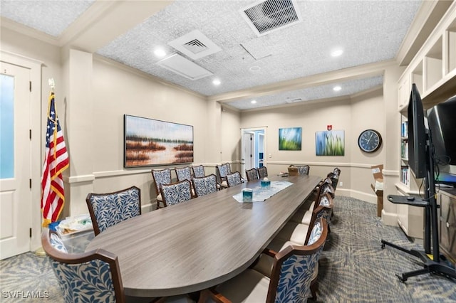 dining area with carpet, ornamental molding, and a textured ceiling