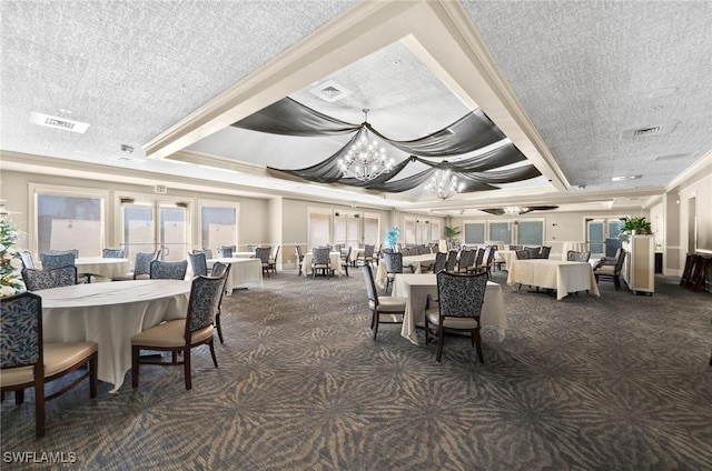 carpeted dining space featuring a notable chandelier, ornamental molding, and a tray ceiling