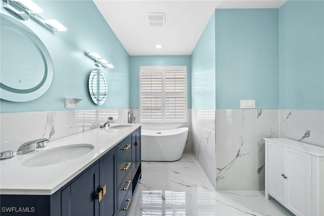 bathroom featuring vanity, tile walls, and a bathing tub