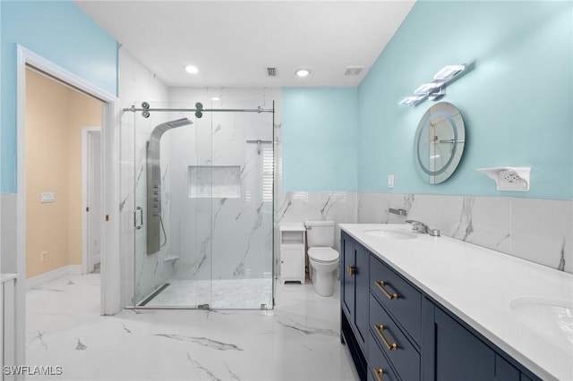 bathroom with vanity, an enclosed shower, and toilet