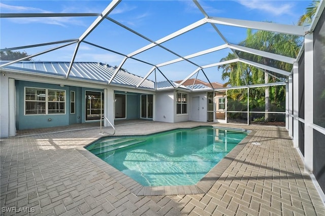 view of swimming pool with a lanai and a patio area