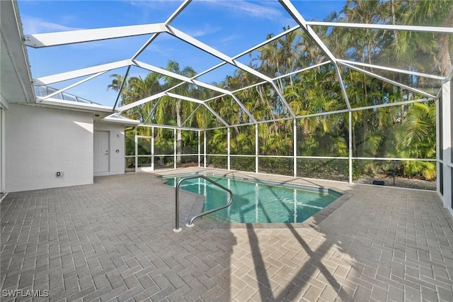 view of pool with a lanai and a patio area