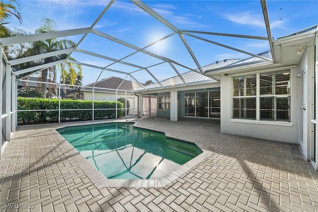 view of swimming pool with a lanai and a patio