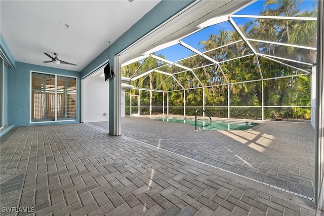 view of patio / terrace with ceiling fan and glass enclosure