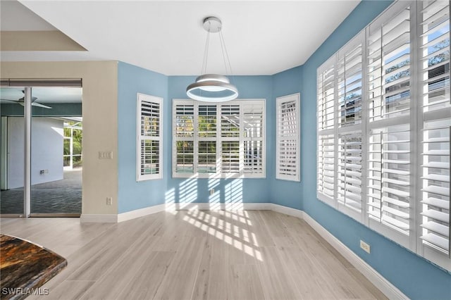 unfurnished dining area featuring light hardwood / wood-style flooring