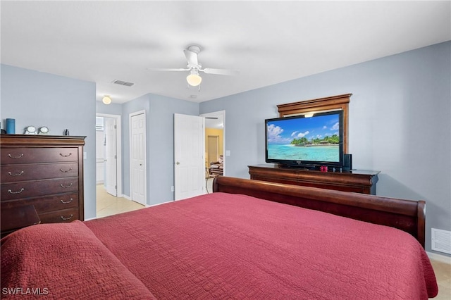 bedroom featuring ceiling fan, ensuite bathroom, and light carpet