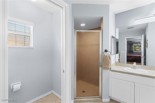 bathroom featuring tile patterned floors, vanity, and a shower with shower door