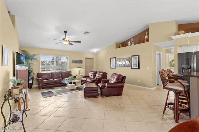 tiled living room featuring ceiling fan and lofted ceiling