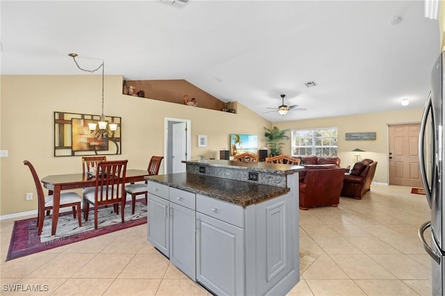 kitchen featuring ceiling fan with notable chandelier, gray cabinets, light tile patterned flooring, and hanging light fixtures