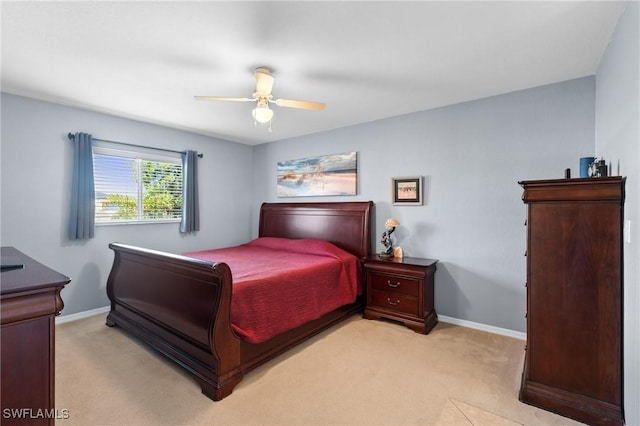 bedroom featuring ceiling fan and light carpet