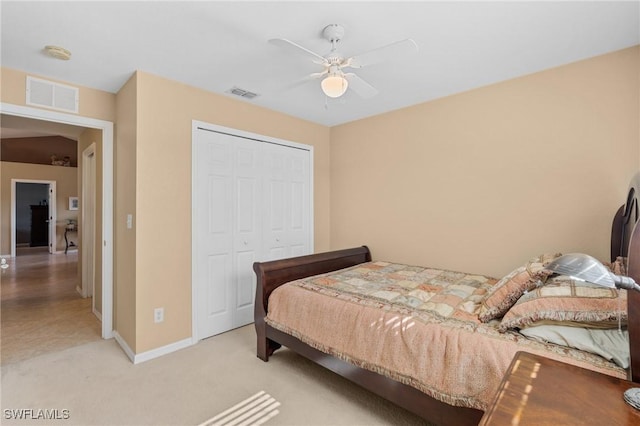 bedroom with ceiling fan, a closet, and light carpet