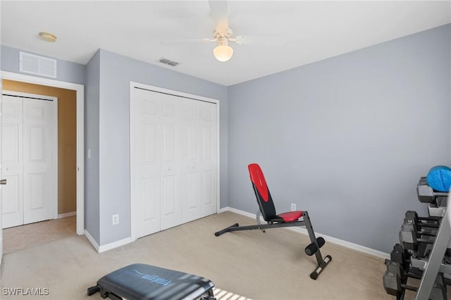 workout area featuring ceiling fan and light carpet