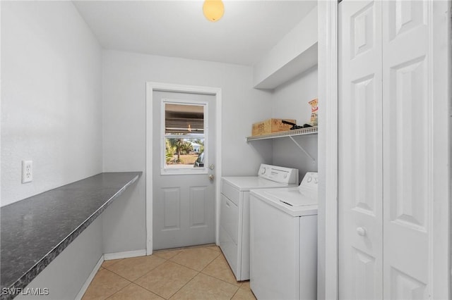 laundry room featuring light tile patterned floors and washing machine and dryer