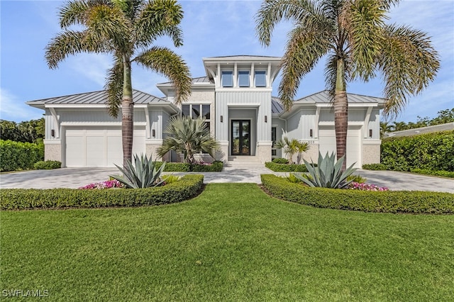 view of front facade featuring a garage and a front yard