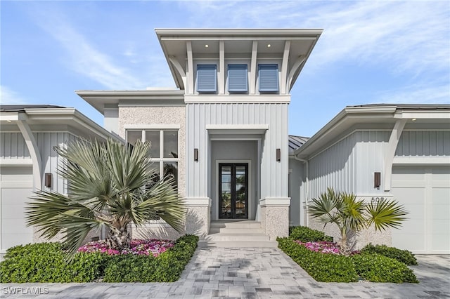 exterior space with a garage and french doors