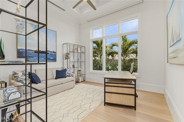 interior space featuring light wood-type flooring, ceiling fan, and ornamental molding