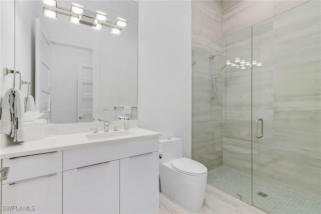 bathroom with vanity, a shower with shower door, and toilet