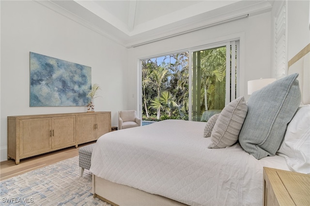 bedroom featuring light hardwood / wood-style floors and crown molding