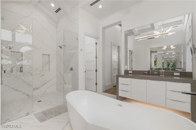 bathroom featuring a notable chandelier, vanity, and shower with separate bathtub