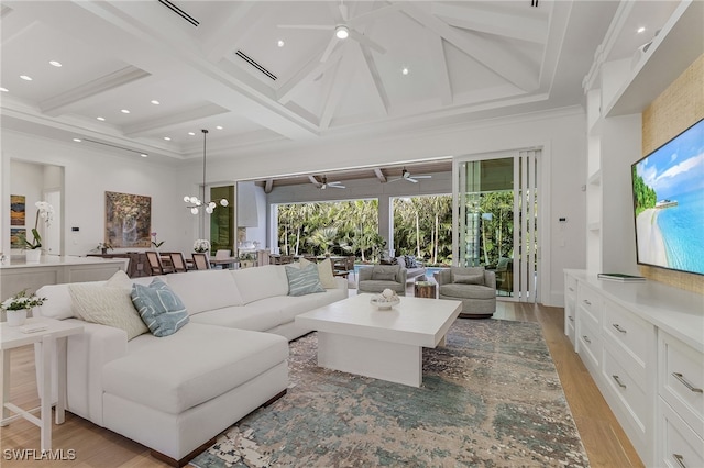 living room featuring a towering ceiling, light wood-type flooring, coffered ceiling, a notable chandelier, and beamed ceiling