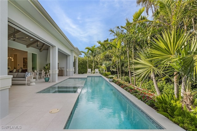 view of pool with a patio area and ceiling fan