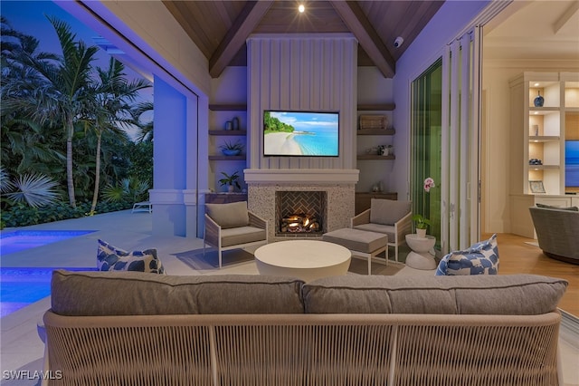 living room featuring built in shelves, lofted ceiling with beams, wood ceiling, and exterior fireplace