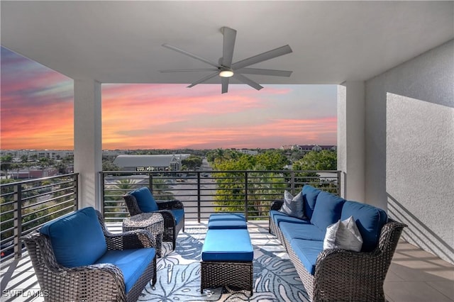 balcony at dusk with outdoor lounge area and ceiling fan