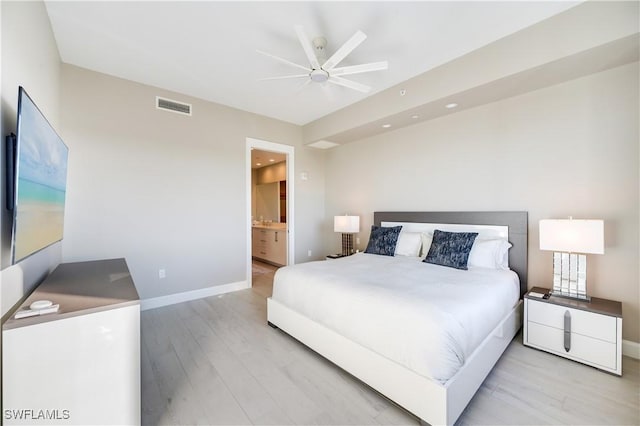 bedroom with ensuite bath, ceiling fan, and light hardwood / wood-style floors