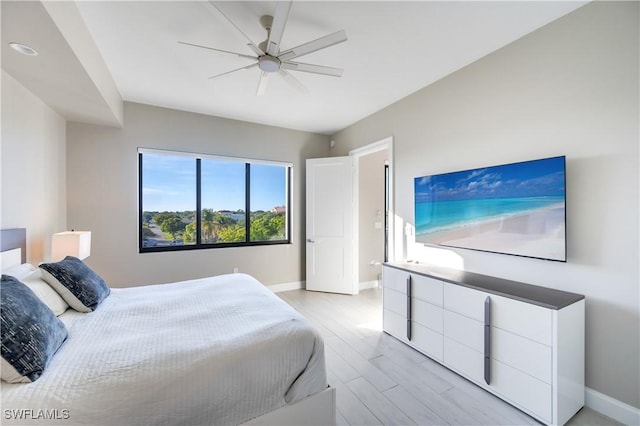 bedroom with ceiling fan and light wood-type flooring