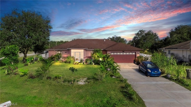 view of front facade with a yard and a garage